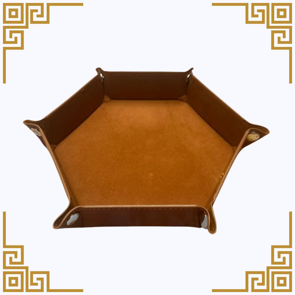 Hexagonal brown leather dice tray on a white background