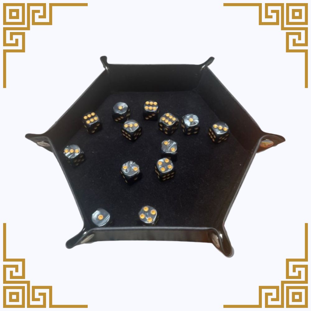 Black dice tray with dice on a white background
