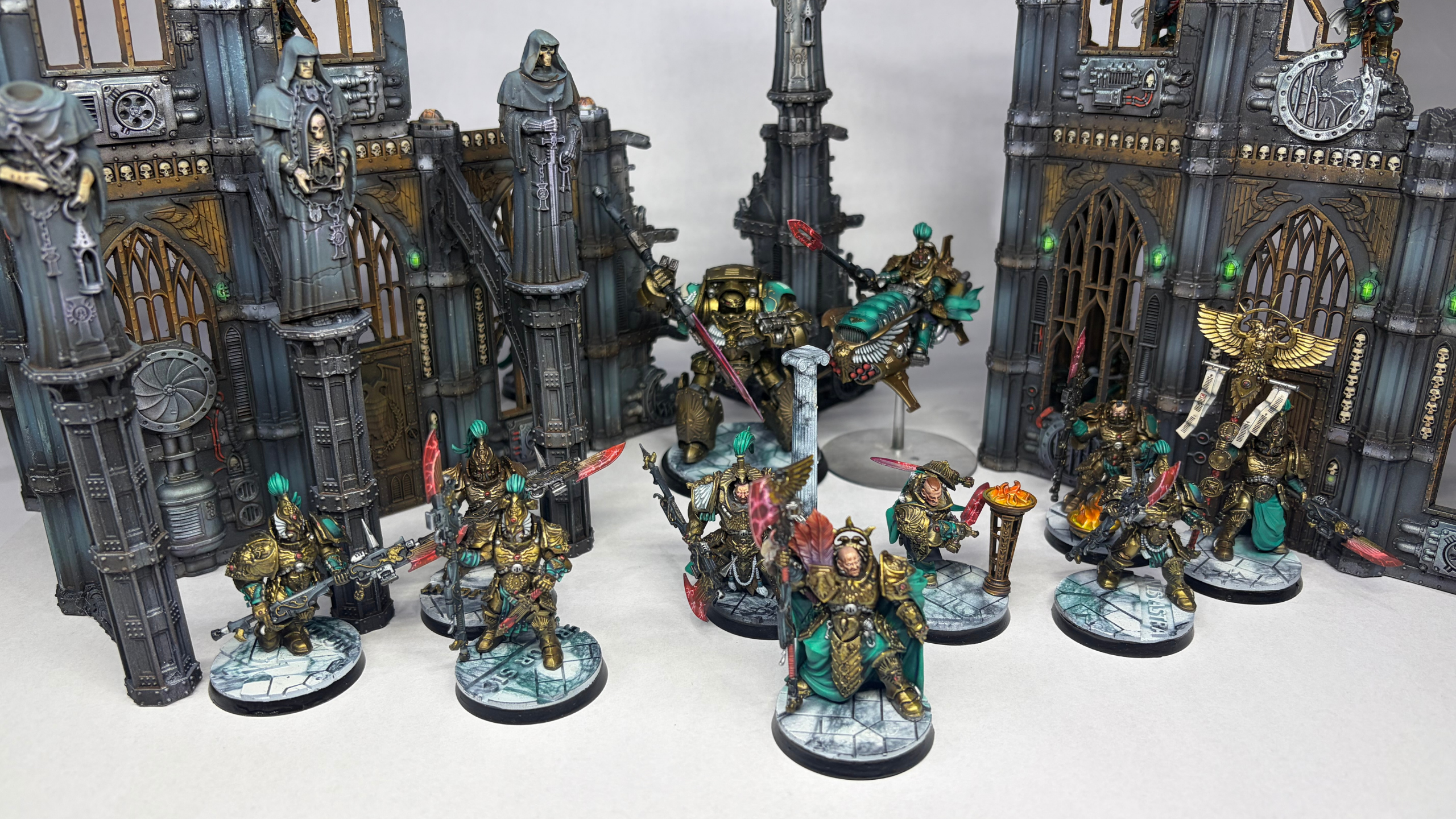 Collection of Warhammer 40k custodes detailed models on a white background
